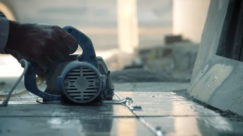 Worker cutting stone slab using electric cutter at construction site Stock Footage 319074202