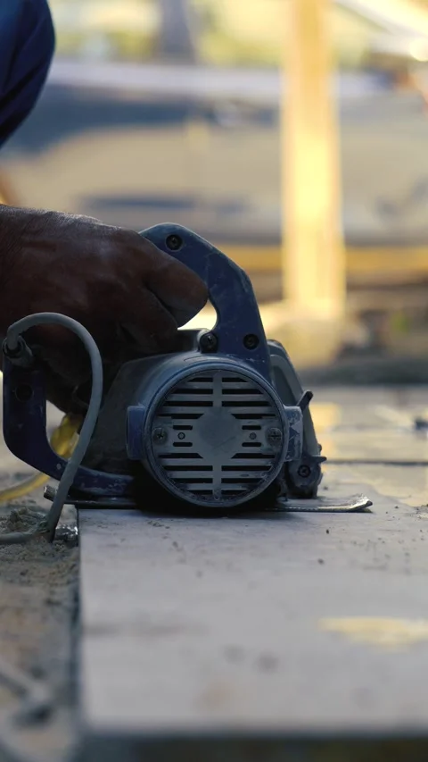Worker cutting stone slab using electric cutter at construction site 스톡 동영상 319074221