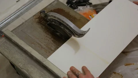 Worker cutting tiles on tile cutter Stock Footage 128411996