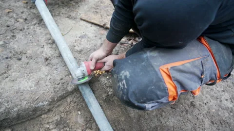 Worker cutting tube with angle grinder Stock Footage 158972595