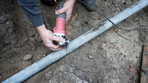 Worker cutting tube with angle grinder Stock Footage 158972666