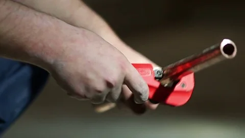 Worker cutting water pipe preparing for heating installation using modern tool Stock Footage 72962998