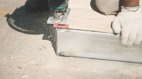 Worker cutting wood with a wood saw outside hand Stock Footage 137526341