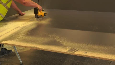 Worker cutting a wooden panel with a circular saw in a workshop Stock Footage 344905172