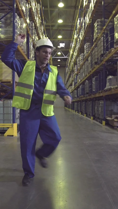 Worker dancing between racks in warehouse Stock Footage 224831223