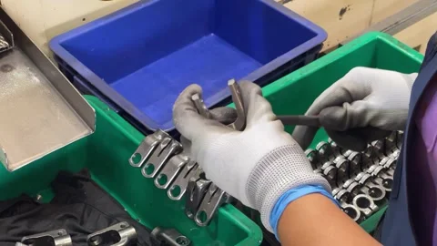 Worker Deburring Metal Parts with Hand File Before Packaging Stock Footage 339530729