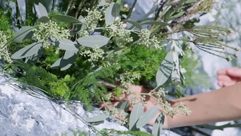 Worker decorates a place with flowers Stock Footage 136144694