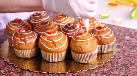 Worker decorating pastries at a commercial bakery Stock Footage 61715217