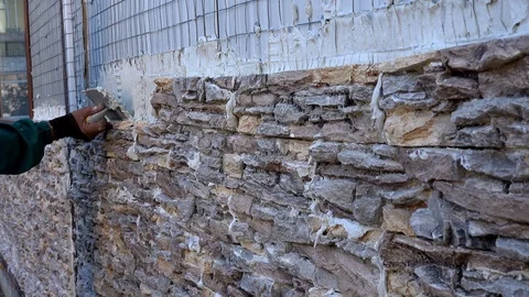 Worker decorating a wall with ornamental stone tiles pressing and fixing a tile 스톡 동영상 97289211