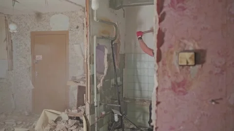 Worker Demolishing Soviet Apartment Wall During Renovation, Slow Motion Stock Footage 340981509