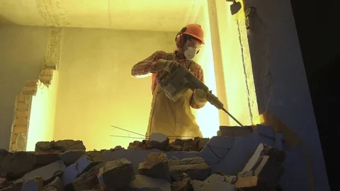Worker with demolition hammer breaking interior wall Video stock 84179244