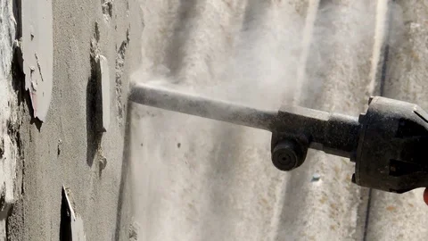 Worker with demolition hammer breaking interior wall Stock Footage 90186351