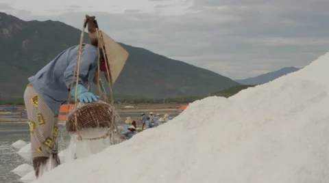 Worker Depositing Salt on Large Hill Stock Footage 42425781