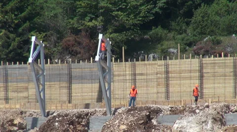 Worker descending from scaffold on mountain construction site Stock Footage 28499857