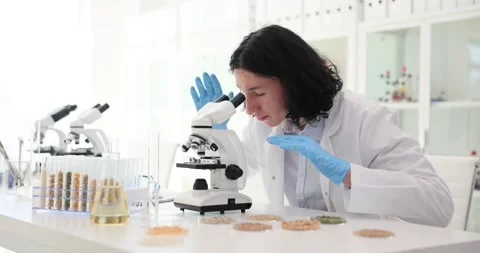 Worker detects presence of harmful bacteria using microscope Stock Footage 285640344