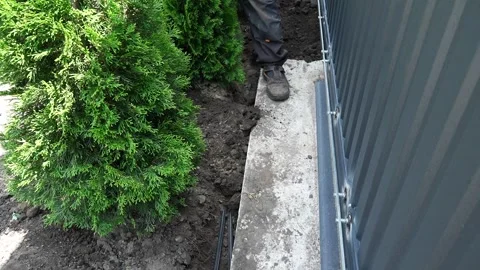 Worker Digs electric wires into the ground with a Shovel Stock Footage 258645764