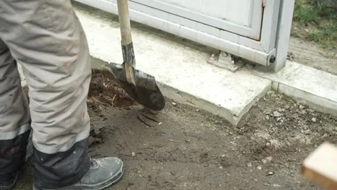 Worker Digs electric wires into the ground Stock Footage 268704814