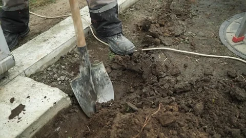 Worker Digs electric wires into the ground Stock Footage 268704820