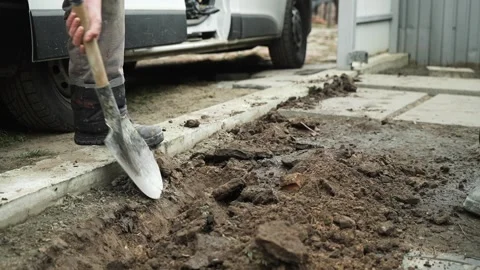 Worker Digs electric wires into the ground Stock Footage 268704823