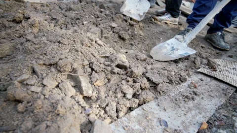 Worker digs soil with shovel at construction site Stock Footage 158973385