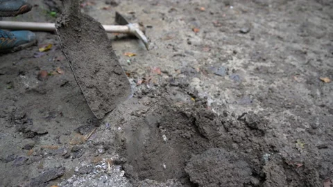 Worker digs soil with shovel at construction site Stock Footage 158980178