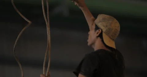 Worker Directs The Movement of a Bridge Crane Hook (4K) Stock Footage 60773875