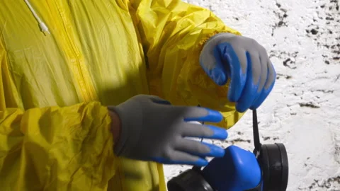 Worker in disposable coverall wearing protective gloves and respirator Stock Footage 111273904