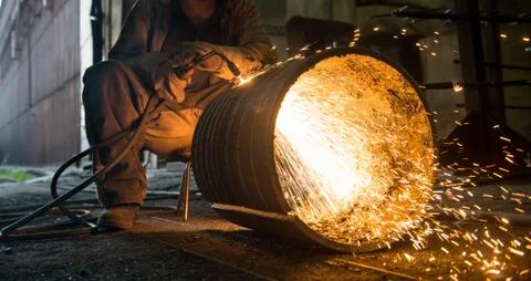 Worker doing a industrial welding in a workshop Stock Photos