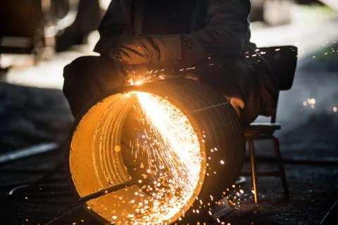 Worker doing a industrial welding in a workshop Stock Photos