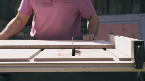 Worker is doing joinery works on circular saw colseup view. Man cuts wood boards Stock Footage 90101502