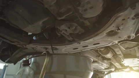 Worker drains old motor engine oil to replace in car service, close up Video stock 140146587