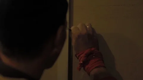 Worker drawing a line on a wall using a ruler in building site. Video stock 110771517