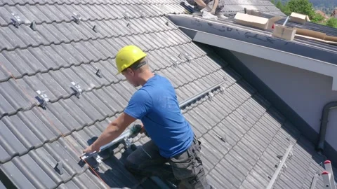 Worker drill and fix rail into roof of house. Solar panels installation Vídeos de archivo 135643148