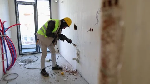 Worker Drilling in Apartment Renovation Stock Footage 314452581