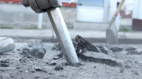 Worker drilling concrete with jackhammer. Man with drill breaking up concrete. Stock Footage