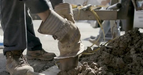 Worker drilling the ground using drill auger Stock Footage 145282409