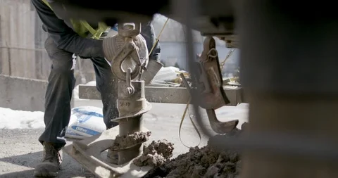 Worker drilling the ground using drill auger Stock Footage 145282664