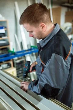 Worker with drilling mashine in workshop Stock Photos