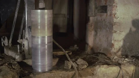 A worker drills a hole in concrete with a diamond drill Stock Footage 152935771