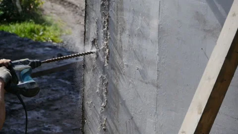 Worker drills a hole in a concrete wall Stock Footage 159448404