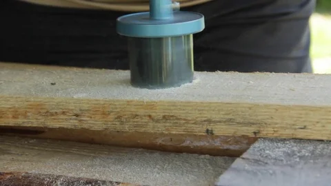 The worker drills a hole special nozzle hole in a wooden board Stock video Stock Footage