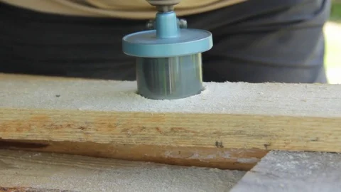 The worker drills a hole special nozzle hole in a wooden board Stock Footage 76152837