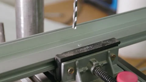 A worker drills into a metal frame after spreading some coolant. Stock Footage 163081909