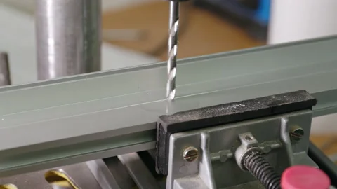 A worker drills into a metal frame Stock Footage 163084412