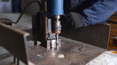 The worker drills sheet metal by drilling machine, metal cutting with lot of Stock Footage 81983124