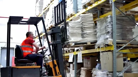 Worker driver moving forklift pallet at warehouse Stock Footage 84734178