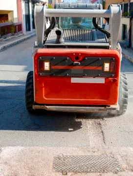 Worker driver Skid steer remove Worn Asphalt during repairing Road Works Stock Photos
