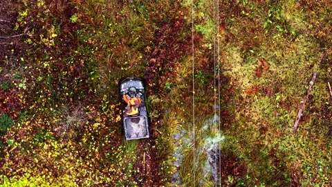A Worker Drives a Small Utility Vehicle Through a Colorful, Rugged Landscape Stock Footage 325685223