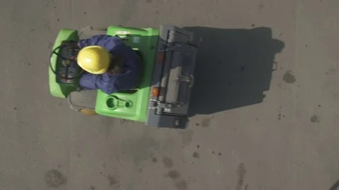 Worker drives sweeper right to left 스톡 동영상 79160811