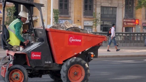 Worker driving a construction machine with container full of rubble Stock Footage 118277971